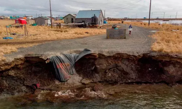 Climate change erosion caused by melting permafrost tundra and the disappearance of sea ice which formed a protective barrier, threatens houses from the Yupik Eskimo village of Quinhagak on the Yukon Delta in Alaska last month. Photo: Mark Ralston, AFP