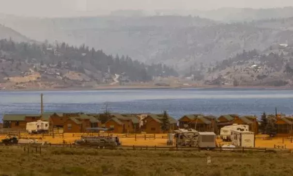 A view of Panguitch Lake with the Brian Head fire burning in the distance on Saturday, June 24, 2017. Photo: Jordan Allred, The Spectrum and Daily News