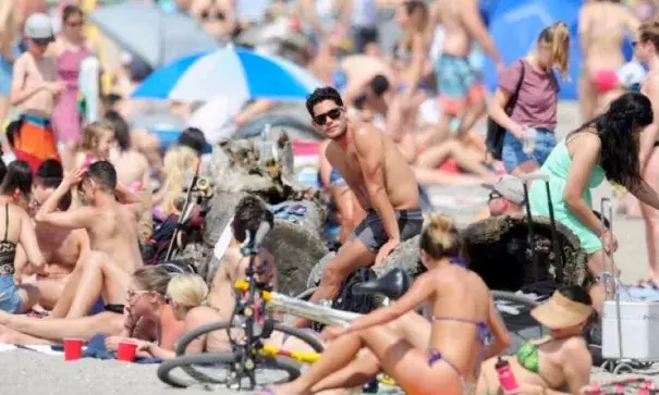 Sun seekers pack Kits Beach in Vancouver on Sunday as temperatures neared record highs. Photo: Nick Procaylo