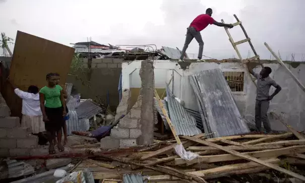  Residents repair their homes destroyed by Hurricane Matthew in Les Cayes. Photo: Dieu Nalio Chery/AP