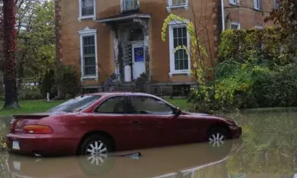 A car sits in flood water in Milesburg. Photo: John Boogert, Centre Dailiy