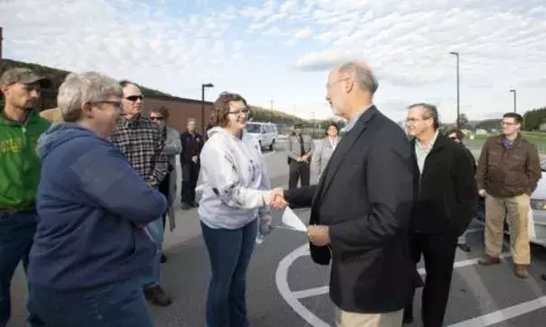 Pennsylvania Gov. Tom Wolf shakes hands with Meg Talarigo, center, and her mother, Lisa Talarigo, at Bald Eagle Area High School on Sunday. Photo: Phoebe Sheehan