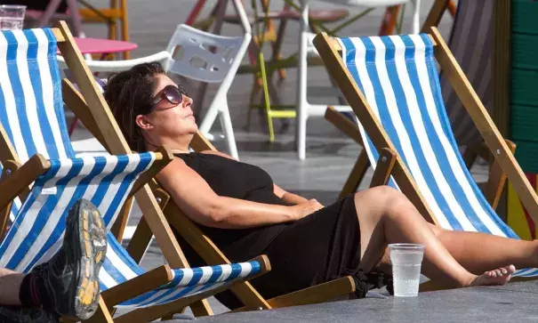 A woman sunbathes on a deckchair in central London. Photo: Amer Ghazzal, Rex, Shutterstock