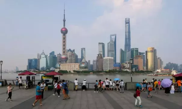 Umbrellas help people beat the heat on Shanghai’s waterfront on Friday, July 21, 2017, when the city set an all-time high temperature record of 40.9°C (105.6°F). Photo: STR/AFP/Getty Images