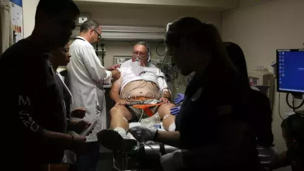 Doctor David Farcy works on David Patlak, acting as a cardiac arrest patient during an emergency drill, at Mount Sinai Medical Center's Emergency Room, July 24, 2015. Floridians are already experiencing the health effects of climate change, including heat stroke and heart problems, doctors say. Now some medical practitioners are banding together to educate and advocate for their patients as the Florida Clinicians for Climate Action. Photo: Emily Michot, Miami Herald