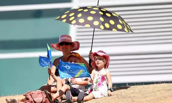 Supporters take shelter from the heat during the under-19 Cricket World Cup match between New Zealand and England in Queenstown. Credit: Dianne Manson-IDI, Getty Images