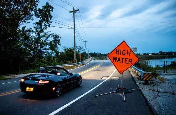 A vehicle crosses the Appoquinimink River along Old State Road in Odessa, Del. (Kyle Grantham for The Washington Post)