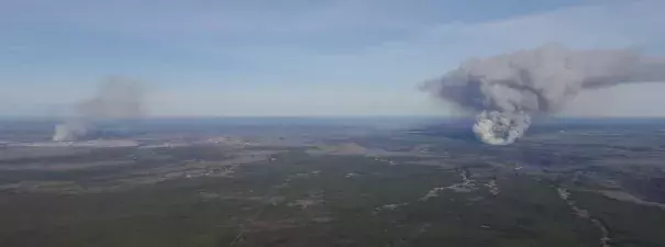 These two fires started at about the same time on May 1, 2016 near Fort McMurray, Alberta, Canada. Seen just after they started, on the left is the MMD-004 fire inside the city limits of Fort McMurray. The Horse River Fire, often referred to as the Fort McMurray Fire, is on the right. Alberta Forestry photo.