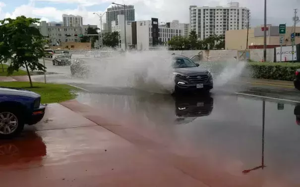 An SUV splashes down Miami Beach's Alton Road Sunday morning. Photo: David J. Neal