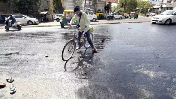 File photo: A cyclist in Ahmedabad struggles as tar melts on a road in summer last year. Photo: Yogesh Chawda, BCCL Ahmedabad