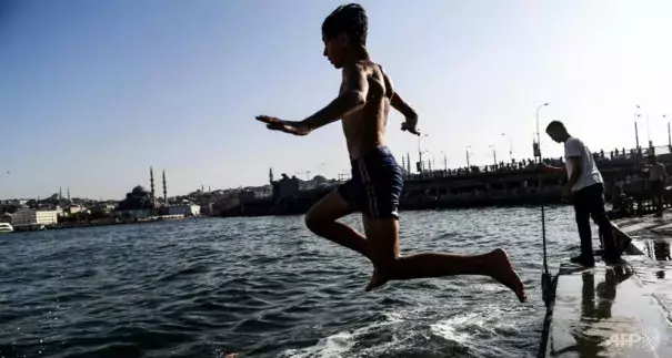 In Istanbul, many people took a dip in the Bosphorus to cool down. Photo: Bulent Kilic, AFP