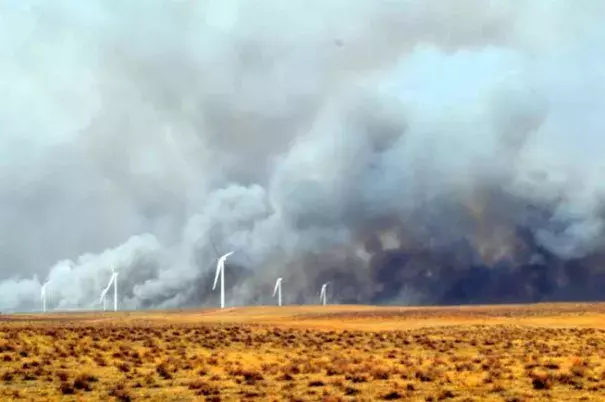 Smoke billows behind wind turbines north of Fleming Monday afternoon. A wildfire burned out of control from the Crook and Proctor area south and east into Phillips County, fueled by dry conditions and strong winds. Photo: Jeff Rice, Sterling Journal-Advocate