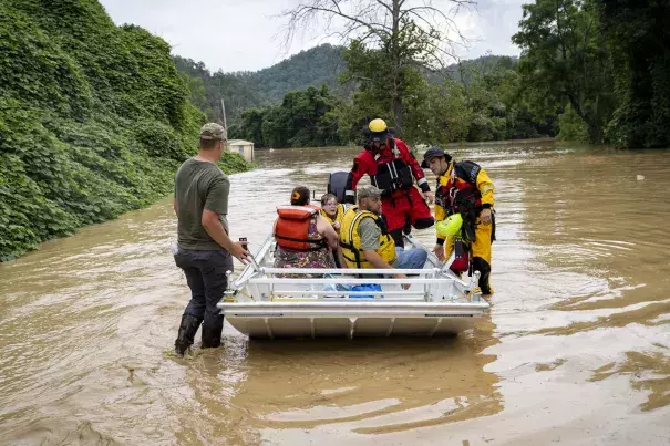 A rescue team from the Jackson Fire Department assists people out of floodwaters downtown on July 28, 2022 in Jackson, Kentucky. (Credit: Michael Swensen/Getty Images)