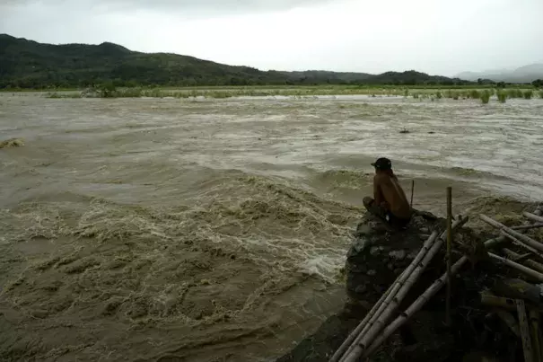 A man looks at the rising water level of the Magat River caused by continuous rains of Typhoon Koppu at Bayombong, Nueva Viscaya, Philippines, on Sunday, October 18, 2015. Koppu wrecked houses, tore down trees, and unleashed landslides and floods, forcing thousands to flee as it pummeled the northern Philippines on Sunday. Image credit: STR/AFP/Getty Images.