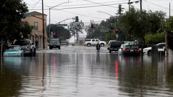 A man walks through floodwaters Monday in Salinas. Forecasters issued flash flood warnings throughout the Bay Area and elsewhere in Northern California. Photo: Nic Coury / Monterey County Weekly