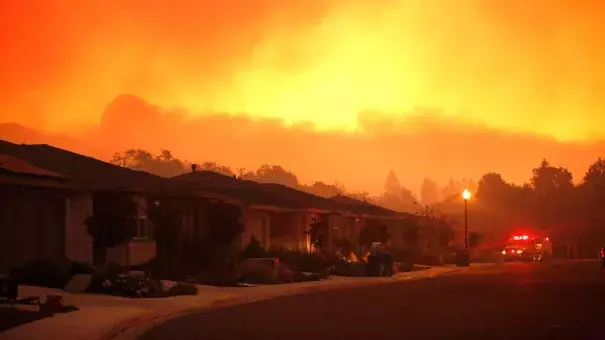 Firefighters monitor flames threatening the Oakmont community along Highway 12 in Santa Rosa. Photo: Genaro Molina / Los Angeles Times