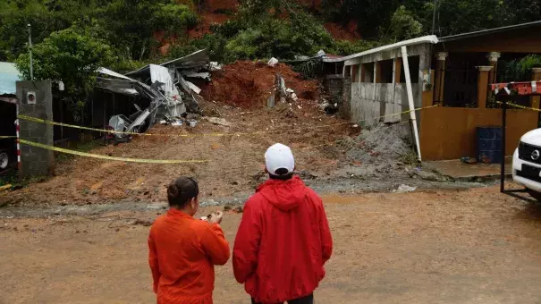 Panamanian civil defense workers view a mudslide that destroyed a home and killed the couple inside in Arraijan, on the outskirts of Panama City on Tuesday. Photo: Associated Press