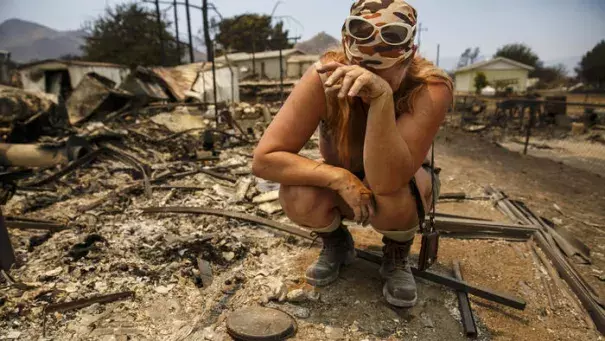 Tyra Rene Fuller tears up a she finds a porcelain cast of her daughter's handprint while soring through what's left of her belongings after her home was destroyed by the Erskine fire in Lake Isabella, Calif. Photo: Marcus Yam / Los Angeles Times
