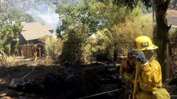 In Silver Lake, a fire at a home quickly spread to brush along the 2 Freeway, prompting firefighters to call for more resources and air support. The freeway was closed in both directions near its terminus in Echo Park. Photo: Dillon Deaton / Los Angeles Times