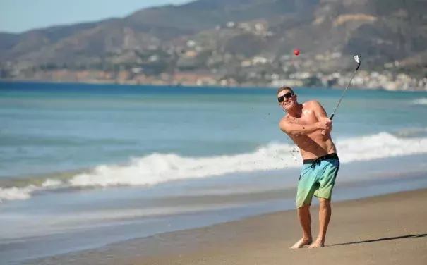 Dan Charcoal, who is vacationing in Southern California from Maui, golfs on Zuma Beach during a hot winter day Monday. Photo: Wally Skalij, Los Angeles Times