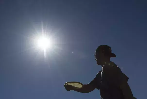Ian Kellam of Costa Mesa fires a shot as he and friends play disc golf at a course in Huntington Beach earlier this month. Southern California has seen above-average heat in February so far. Photo: Ed Crisostomo, AP