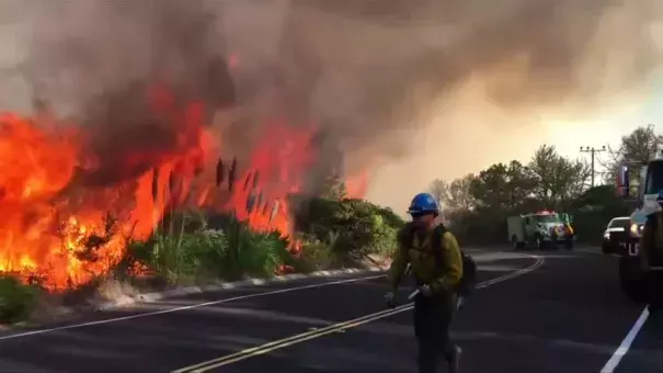 Firefighters battle a wildfire at Vandenberg Air Force Base in California. Photo Linda So