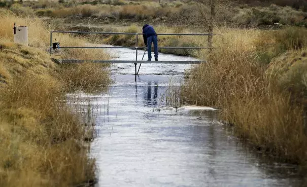 A DWP employee takes water readings March 25 on a tributary of the Owens River near Bishop. With a season of record snowfall in the Sierras, the Owens Valley is preparing for possible floods when everything starts melting. Photo: Mark Boster, LA Times