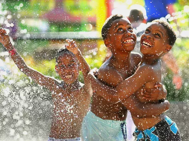 Nine-year-old William Williams, right, and his brother Xavier Robertson, 10, wait for the Big Splash machine at the Como Town water park to dump water on them in St. Paul, Minn. Temperatures hit 92 degrees in St. Paul on Wednesday, with a heat index of 97 degrees. Photo: John Autey / Associated Press