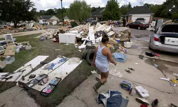 A resident walks through a flood-damaged neighborhood in Louisiana. The state’s governor has requested an addition $2bn in emergency aid from the federal government. “Simply put, we cannot recover without it,” Edwards said at a House subcommittee hearing. Photo: Jonathan Bachman/Reuters