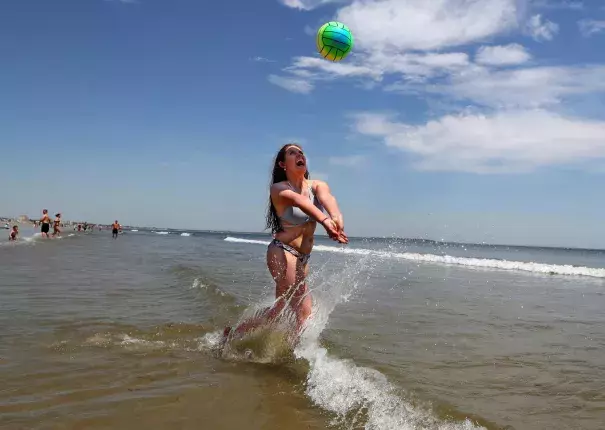 Nessa King of Wyndham, Maine, returns a shot while playing volleyball in record breaking heat at Old Orchard Beach, Maine, Thursday, May 18, 2017. King was one of hundreds of Maine high school seniors who skipped school to enjoy a day at the beach with classmates. Photo: Robert F. Bukaty, AP