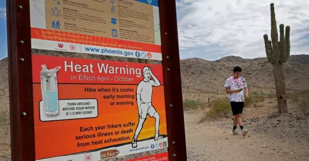 A morning walk at the South Mountain Preserve in Phoenix last month. Afternoon highs in Phoenix last summer averaged 106 degrees Fahrenheit, almost 3 degrees hotter than the average for the second half of the 20th century. Credit: Matt York, Associated Press