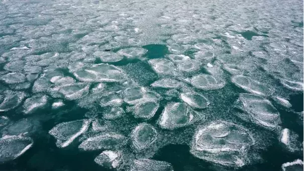 FILE – Lake Michigan is covered with snow and ice in Chicago, Jan. 17, 2022. (Credit: AP Photo/Nam Y. Huh, File)