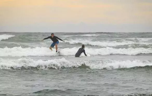 Taking advantage of Nahant Beach’s waves on Labor Day morning were Nels Nelson of Somerville and Odette Bakker, visiting from the Netherlands. Photo: Dina Rudick, Globe Staff