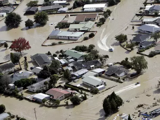 Jet boats drive through the flooded streets of the North Island town of Edgecumbe in New Zealand Andrew Warner/The Bay of Plenty Times/AP