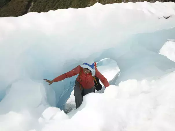In this Feb. 6, 2016 photo, tourists who have taken a helicopter trip onto the Fox Glacier climb through a hole in the ice in New Zealand. The Fox and Franz Josef glaciers have been melting at such a rapid rate that it has become too dangerous for tourists to hike onto them from the valley floor, ending a tradition that dates back a century. Photo: Nick Perry, AP