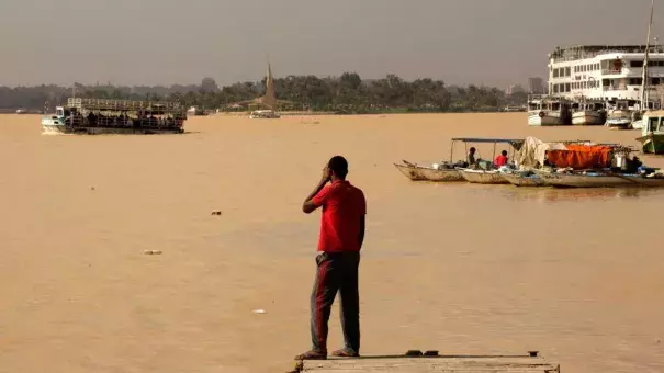 An Egyptian fisherman stands watching the Nile River as water appears a murky brown color due to the flooding in southern provinces, Beni Suef and Sohag south of the capital, in Cairo, Egypt, Tuesday, Nov. 1, 2016. Photo: Amr Nabil, AP