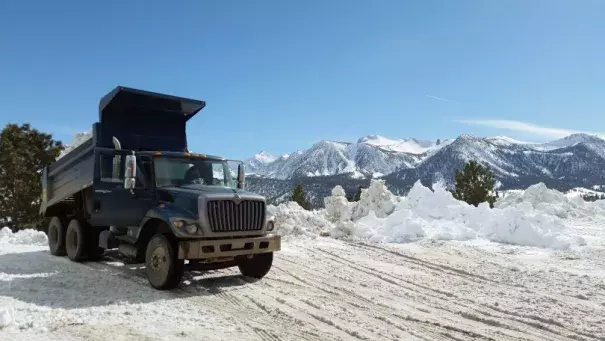 This March 2, 2017 photo provided by the California National Guard shows a Guard dump truck helping to clear huge snow drifts from the Eastern Sierra town of Mammoth Lakes, Calif. Photo: California National Guard via AP