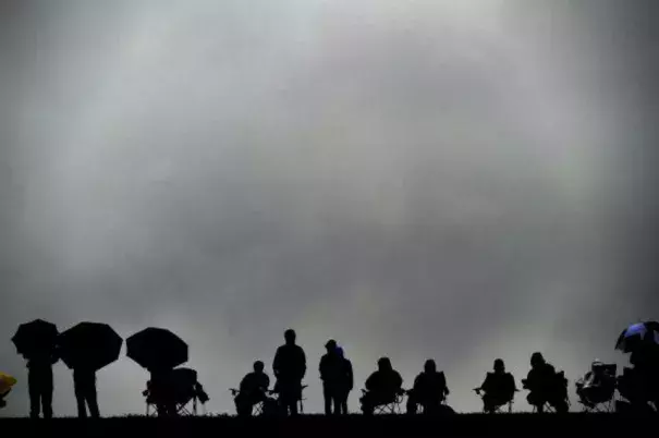 Spectators brave the rain to watch the qualifying session ahead of the the U.S. Formula One Grand Prix at the Circuit of the Americas in Austin, Texas, on Oct. 25, 2015. Photo by Jewel Samad/AFP/Getty Images