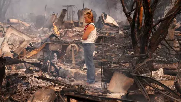 Terrie Burns stands in the middle of her destroyed at the scene of the Tubbs Fire in Santa Rosa, Ca., on Monday October 9, 2017. Massive wildfires ripped through Napa and Sonoma counties early Monday, destroying hundreds of homes and businesses on Monday October 9, 2017. Photo: Michael Macor, The Chronicle