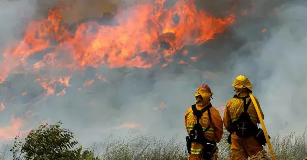 Helicopters sucked water out of a reservoir to drop on flames while air tankers bombarded the flanks of the fire with retardant. Photo: Mike Blake / Reuters