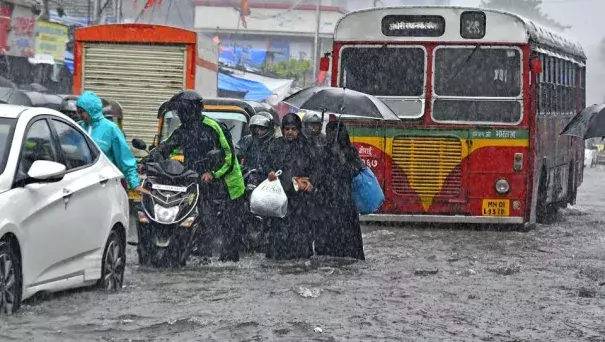 People walk through a flooded road at Andheri in Mumbai on Tuesday, August 29, 2017. Photo: Shashi S Kashyap