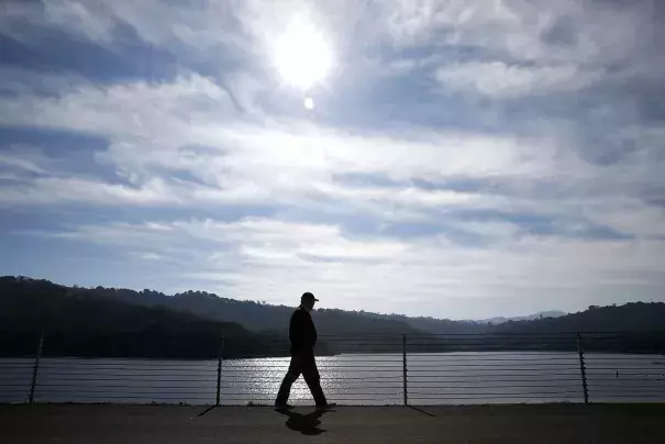 Michael Callow has an unseasonably warm day to enjoy one of his regular walks along the rim of Lafayette Reservoir in the East Bay. Photo: Paul Chinn, The Chronicle