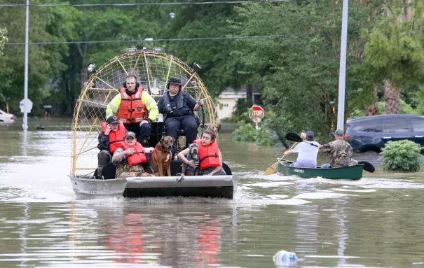 People and their pets are rescued from their homes near Nanes at Baltic in Houston, Texas, Wednesday, April 20, 2016.Thousands of people have been evacuated from their homes and major highways were closed after the rains that started Sunday overwhelmed Houston's bayous. Forecasters have issued another flash flood watch for Houston through Wednesday night. Photo: Steve Gonzales/Houston Chronicle via AP