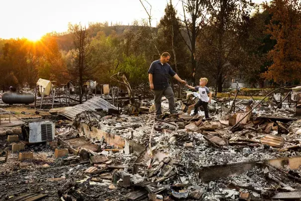 Five-year-old Daniel Wood shows his grandfather, Matthew Schjoth, a wrench he found as they look through the remains of their home on Harlan Drive in Redding that was destroyed in the Carr Fire. Credit: San Francisco Chronicle