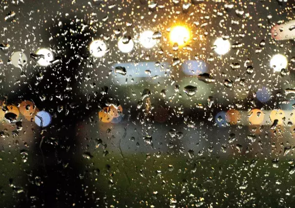 A silhouetted pedestrian is seen through raindrops on a car window as they make their way along Lake Merritt in Oakland, Calif., on Tuesday, February 12, 2019. An atmospheric river is descending on the Bay Area, with rain expected to fall through Thursday. Photo: Carlos Avila Gonzalez, San Francisco Chronicle