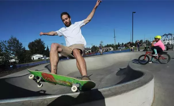 Judd West does a frontside stand up grind on the coping during the grand opening of Anchorage’s first in-ground concrete skate park at North Russian Jack Springs Park on an unusually hot and sunny Sunday in Southcentral Alaska. Photo: Bill Roth / Alaska Dispatch News