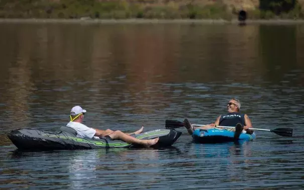 A just-retired Mark Wilson of East Sacramento, left, relaxes in a kayak while floating in Lake Natoma with his friend Danny Langdon of Tahoe Park on Thursday, August 3, 2017 in Sacramento, Calif. Sacramento set a heat-wave record Monday with 41 consecutive days at 90 degrees or warmer. Photo: Randy Pench