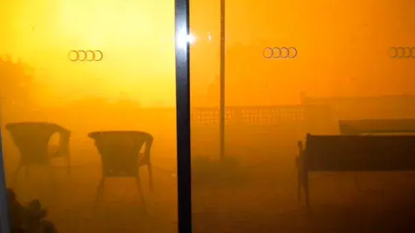 An orange smoke cloud fills Paula Tose's loungeroom window as the Sampson Flat bushfire roars up the valley and towards her home. Photo: Paula Tose