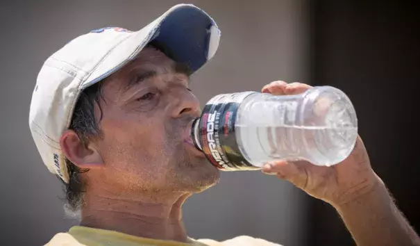 Delfino Villagomez drinks water while laying asphalt on Thursday, July 20, 2017, in Omaha, Neb. Temperatures hit 98°F in Omaha on Thursday after a morning low of 80°F. Photo: Kent Sievers, Omaha World-Herald via AP