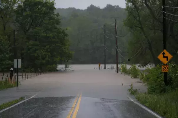 Water from the James River floods onto Farm Road 164 in Springfield, Mo., on Saturday. Photo: Nathan Papes, The Springfield News-Leader via Associated Press